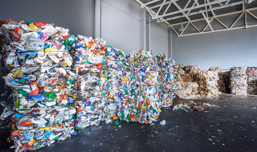 Plastic bales of rubbish at the waste treatment processing plant. Recycling separatee and storage of garbage for further disposal, trash sorting. Business for sorting and processing of waste.