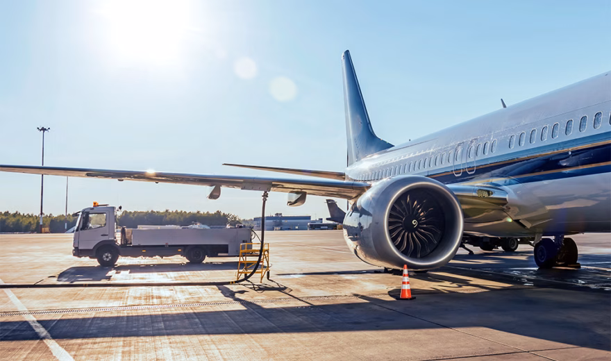An airplane is on the airport apron while ground handling operations are being carried out.